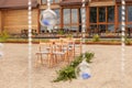 Beautifully decorated outdoors ceremony area with brown chairs Royalty Free Stock Photo