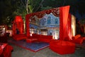 Beautifully decorated red sofas or couch ready for the guests sitting at a wedding ceremony in backyard, night ceremony venue, Royalty Free Stock Photo