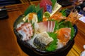 The beautifully decorated sashimi mixed on a black bowl