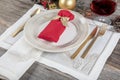 Beautifully decorated table with white plates, glasses, antique cutlery and luxury tablecloths white coral. Christmas table place