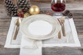 Beautifully decorated table with white plates, glasses, antique cutlery and luxury tablecloths white coral. Christmas table place