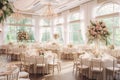 Beautifully decorated wedding reception hall with elegant table settings, lush floral arrangements, and a sparkling chandelier.