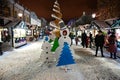 Beautifully decorated winter New Year street with the sale of souvenirs. In center is composition of Christmas trees Royalty Free Stock Photo