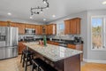 Beautifully designed kitchen with a marble and wood island in a suburban home Royalty Free Stock Photo