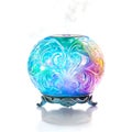 Ornate Sphere Mist Diffuser Emitting Colorful Light and Gentle Steam Royalty Free Stock Photo