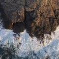 Beautifully detailed aerial drone landscape image of bird`s eye view of waves crashing over rocks at shore