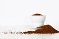 Beautifully displayed coffee grain pile around cup on white background Royalty Free Stock Photo