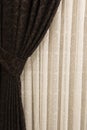 Beautifully draped long curtain on the window in the room. Close up of piled curtain. Luxury curtain, home decor. Brown panels. Wh