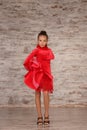 Beautifully dressed little girl dancing in studio