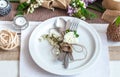 Beautifully elegant decorated table for holiday - wedding or valentine day with modern cutlery, bow, glass, candle and gift