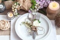 Beautifully elegant decorated table for holiday - wedding or valentine day with modern cutlery, bow, glass, candle and gift