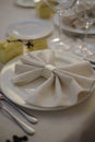 Beautifully elegant decorated table for holiday - wedding or valentine day with modern cutlery, bow, glass, candle and gift,