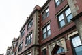 Beautifully featured architectural details on a classic old urban apartment building with corner quoins, leaded windows, and elabo Royalty Free Stock Photo