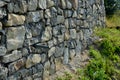 Beautifully folded retaining wall of rough stone joined with cement mortar. brown beige yellow irregular limestone stone. holding