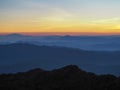 Beautifully graded twilight at Chiang Dao Mountain, the horizon line is orange. Royalty Free Stock Photo