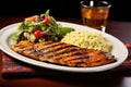 beautifully grilled salmon steak served with couscous and a side salad