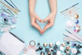 Beautifully groomed fingernails in the form of a heart on the desktop with tools for manicure. Care about the noth Royalty Free Stock Photo