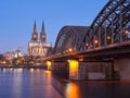 Beautifully illuminated Cologne Cathedral and Hohenzollern Bridge at night. A city in Germany with the river Rhine
