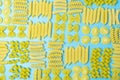 Beautifully laid italian pasta of different types on vivid blue background, top view