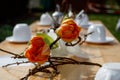 Beautifully laid wooden table with flowers and white coffee set Royalty Free Stock Photo