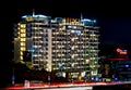 Beautifully lit tall building at night with traffic flow in Pune, Maharashtra, India Royalty Free Stock Photo