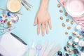 Beautifully manicured nails on the desktop with tools for manicure. Care about the nails