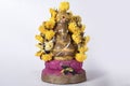 Beautifully painted clay Ganesh statue with garland on white background Royalty Free Stock Photo