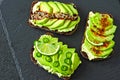 Healthy avocado toasts with spices, lime and chili, presented on a gray stone board. Royalty Free Stock Photo