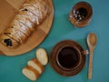 Beautifully served breakfast in earthenware with delicious fresh pastries on a wooden board, a wooden spoon and pussy