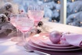 Beautifully decorated table for Christmas dinner with dishes, pink decorations.