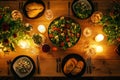 A beautifully set dinner table featuring fresh salads, bread, and candles for a cozy dining experience Royalty Free Stock Photo