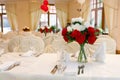 Beautifully set festive table, decorated with a bouquet of roses. The preparations for the party Royalty Free Stock Photo