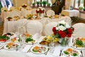 Beautifully set festive table, decorated with a bouquet of roses. The preparations for the party Royalty Free Stock Photo