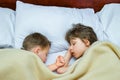 Beautifully sleeping children on the bed at night in the room background