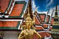 Beautifully stunning gold statue of a Kinnara, a beloved mythical half-human, half-bird creature on the Upper Terrace of Wat Phra