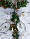 Beautifully styled, festive table setting with natural table runner, candle, plates