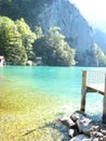 Beautifully view with a landing stage and a turquoise blue swiss lake with snow-covered mountains