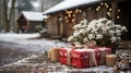 Red Wrapped Christmas Gifts Resting on a Wooden Table in a Winter Snowy Outdoor Scene Near a Log Cabin