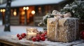 Paper Christmas Gifts Resting on a Wooden Table in a Winter Snowy Outdoor Scene Near a Log Cabin