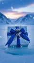 A beautifully wrapped gift box rests on a snowy surface. The box is adorned with Royalty Free Stock Photo