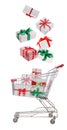 Beautifully wrapped gift boxes falling into metal shopping cart on white background Royalty Free Stock Photo
