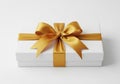 A beautifully wrapped white gift box with gold ribbon Royalty Free Stock Photo