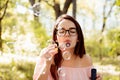 Beautifuln girl blowing soap bubbles