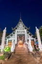 Beautifuly decorated entrance and interior of Wat Lok Moli, Lanna wood-carved Buddhist temple,at night,Chiang Mai,Thailand