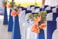Beautifuly decorated with white and blue cloth and flowers chairs
