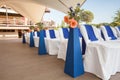 Beautifuly decorated with white and blue cloth and flowers chairs