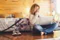 Beautifulyoung adult woman use technology at home with modern laptop computer on her legs - Indoor home bedroom and people working Royalty Free Stock Photo