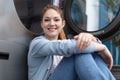 Beautiufl smiling woman sitting on floor doing laundry Royalty Free Stock Photo