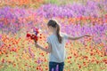 Beautiul caucasian girl holding big bouquet with poppies
