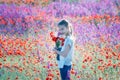 Beautiul girl holding big bouquet with poppies